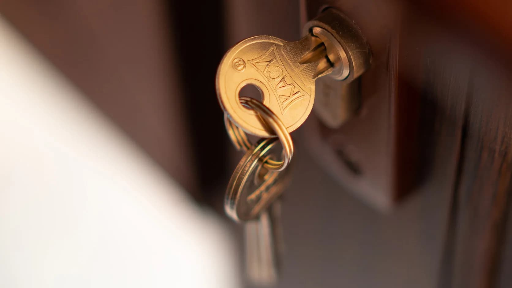 A key turning in a door lock, close up, a locksmith’s work.